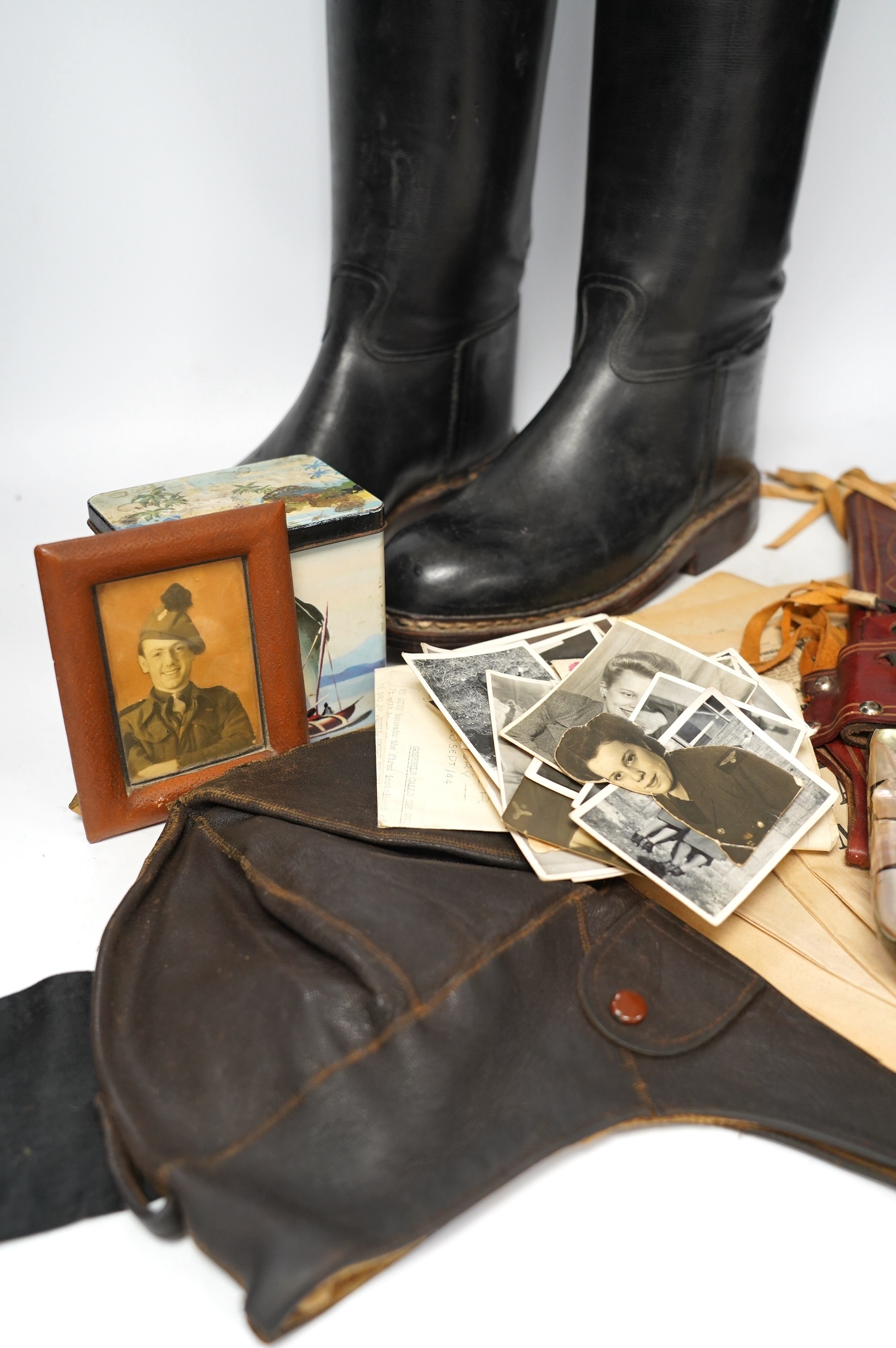 A collection of militaria and WWII related items including; three 1940s copies of the Daily Express with articles related to key events including Dunkirk, a knife in a leather scabbard, a number of photos, an aviation ca